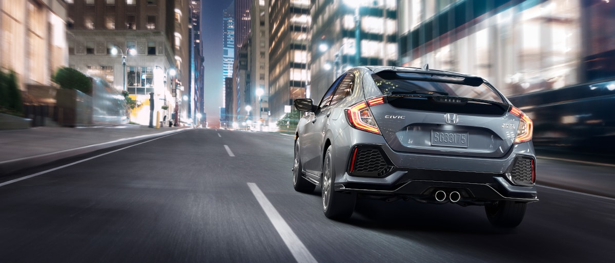 17Civic_Footer.jpg Rearview of the Cici Hatchback driving into the city at night