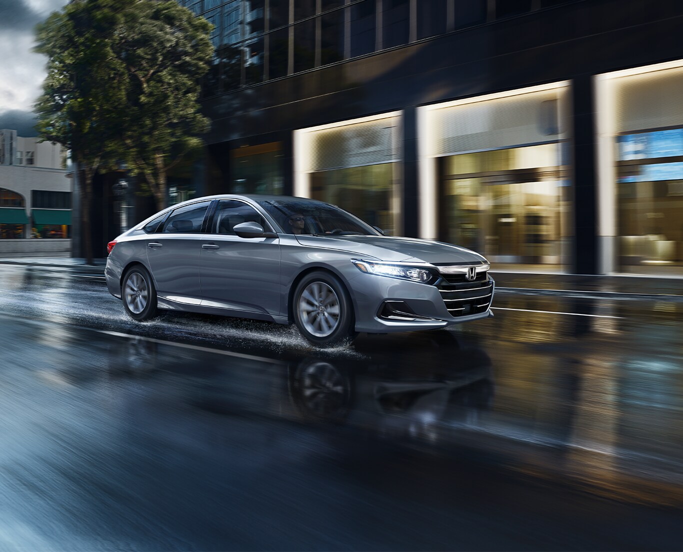 The Top 3 Most Fuel-Efficient Honda Models at Bobby Rahal Honda of State College | Grey Honda Accord driving down the street in the rain 
