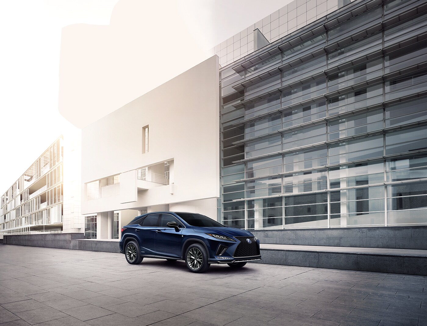 Compare the 2020 Lexus RX and the 2020 Acura MDX at Bobby Rahal Lexus of Lewistown | Blue 2020 Lexus RX parked outside a building