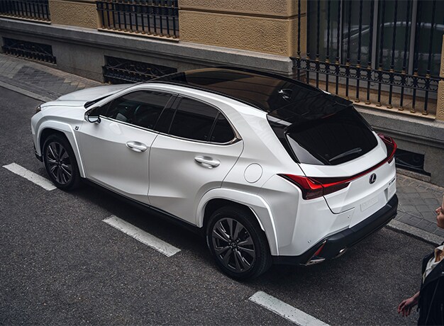 2025 Lexus UXh | Rear profile of a white 2025 Lexus UX Hybrid
