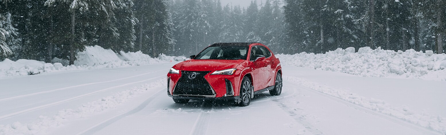 2025 Lexus UXh | Red 2025 Lexus UX Hybrid parked in the snow