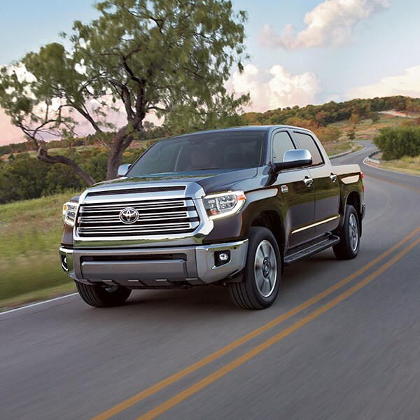 The 2022 Toyota Tundra vs. The 2021 Toyota Tundra at Bobby Rahal Toyota | Dark Gray 2021 Toyota Tundra Driving on Country Road at Sunset