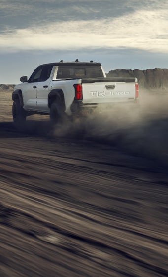 2024 Toyota Tacoma at Bobby Rahal Toyota in Mechanicsburg, PA | Rear profile of a white 2024 Toyota Tacoma TRD Pro trim 