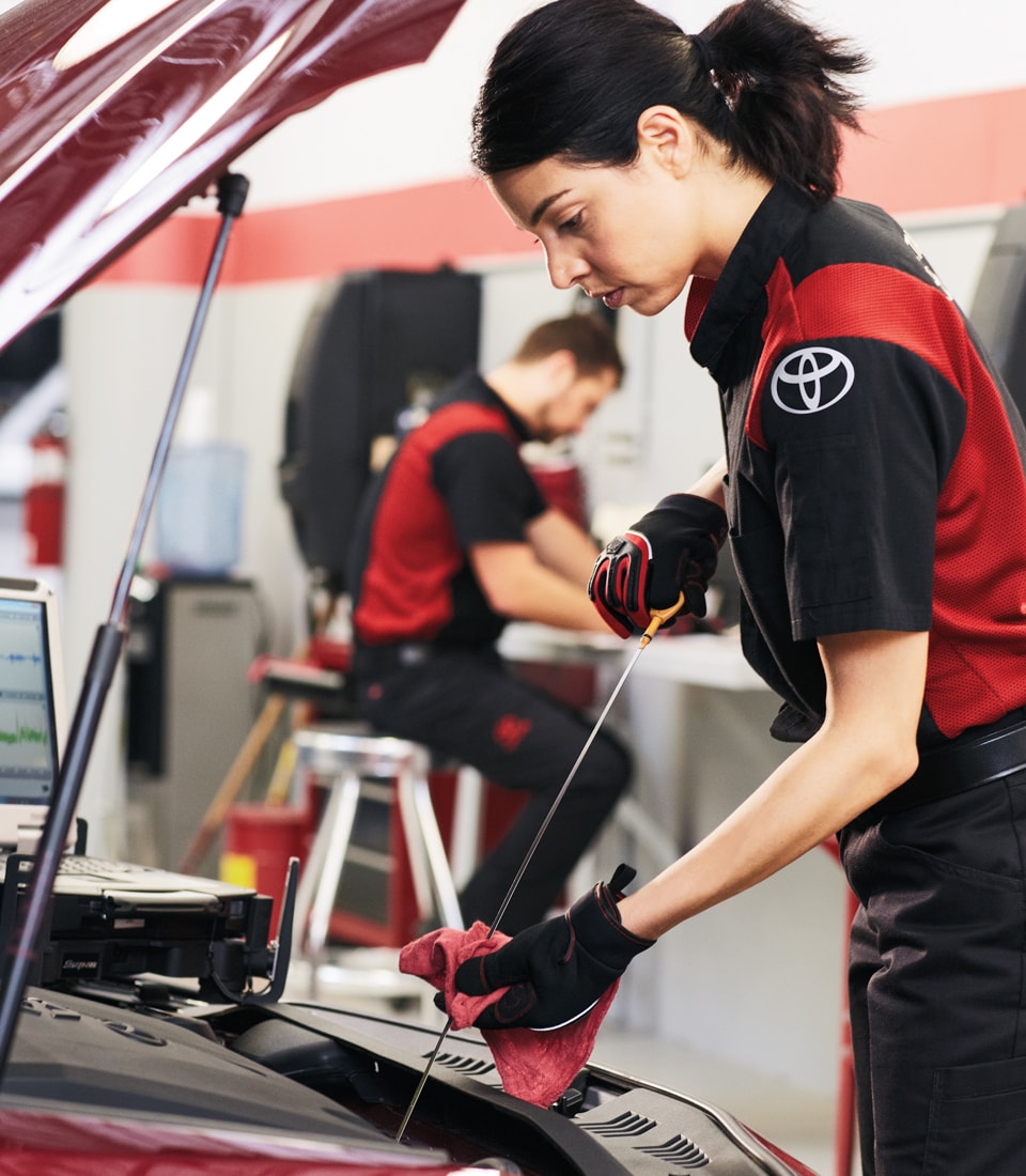 Difference between synthetic oil & conventional oil at Bobby Rahal Toyota | Toyota Technician Changing the Oil of a Vehicle