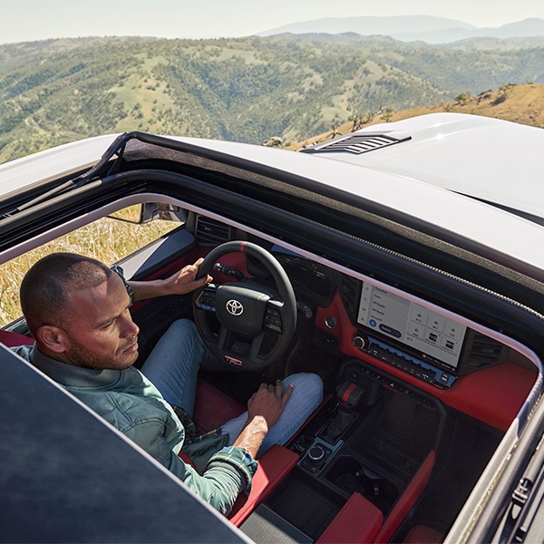 The 2022 Toyota Tundra vs. The 2021 Toyota Tundra at Bobby Rahal Toyota | Sunroof Open Revealing Red Interior of the 2022 Toyota Tundra TRD Pro