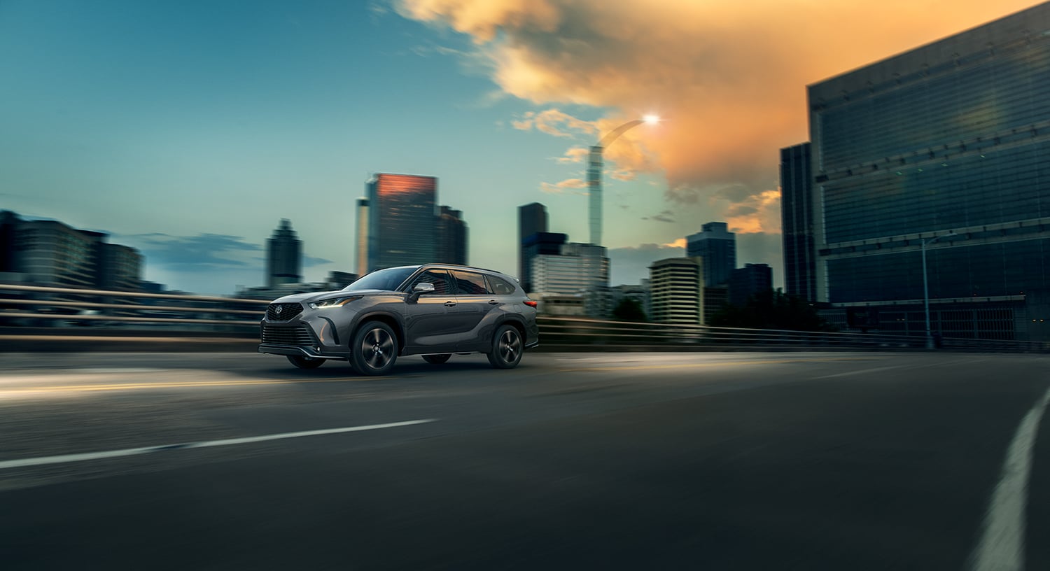 Compare the 2021 Toyota Highlander vs. the 2021 Subaru Ascent at Bobby Rahal Toyota | 2021 Toyota Highlander driving at sunset