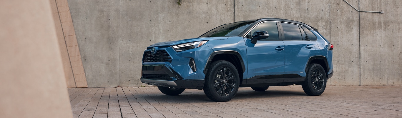What is Paintless Dent Repair? | Bobby Rahal Toyota | Bright Blue Toyota RAV4 parked on brick road on a cloudy day 