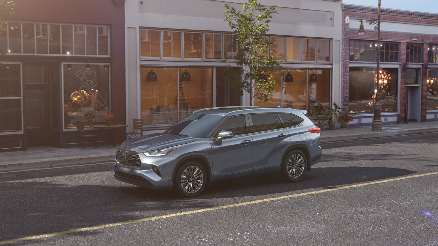 Compare the 2021 Toyota Highlander vs. the 2021 Subaru Ascent at Bobby Rahal Toyota | 2021 Toyota Highlander driving through town