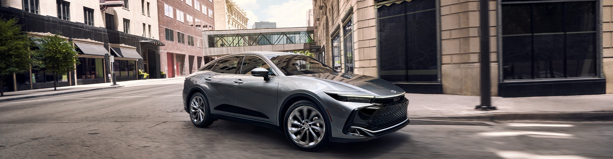 2023 Toyota Crown at Bobby Rahal Toyota in Mechanicsburg, PA | Grey 2023 Toyota Crown making a left turn in the street of a city