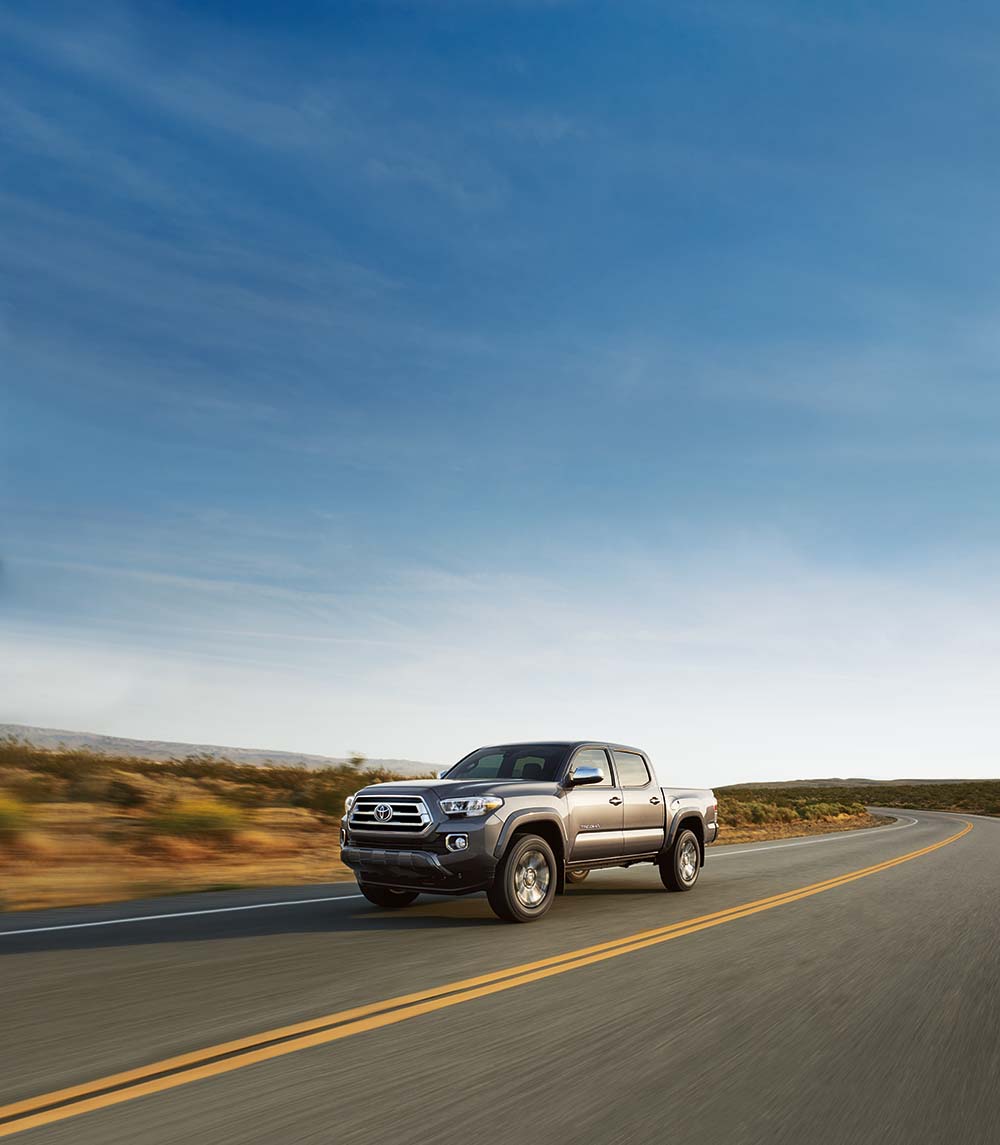 Why drivers should consider an extended warranty on their Toyota at Bobby Rahal Toyota | 2021 Toyota Tacoma driving on a desert road