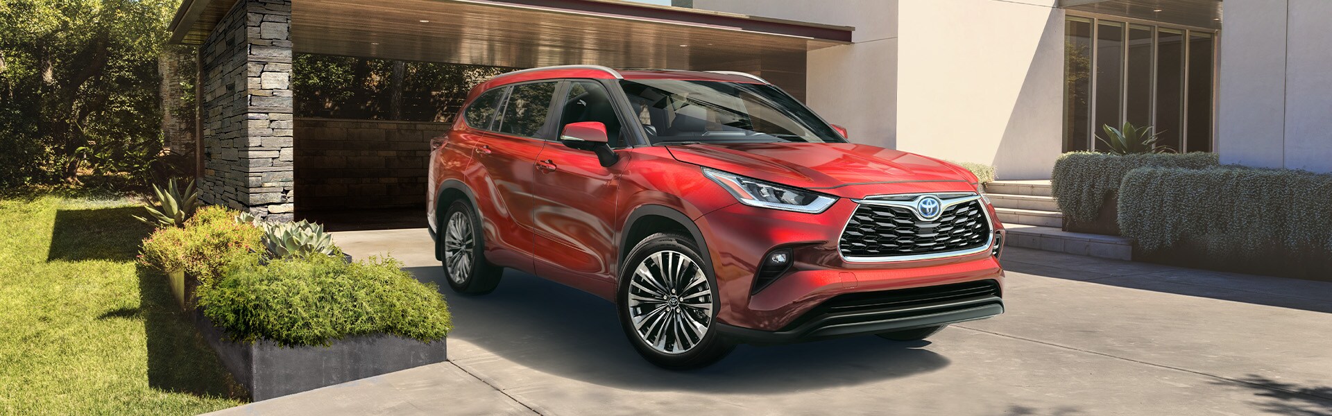 Model Features of the 2022 Toyota Highlander Hybrid at Bobby Rahal Toyota | Red 2022 Highlander Hybrid Parked in Driveway
