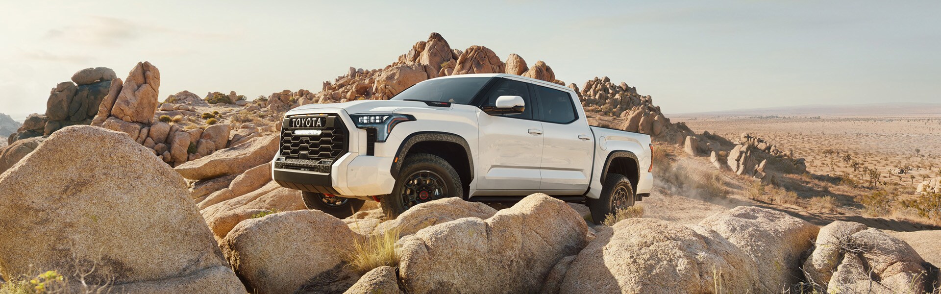 The All-New 2022 Toyota Tundra at Bobby Rahal Toyota in Mechanicsburg, PA | White 2022 Toyota Tundra TRD Pro Off-Roading on Rock Formation
