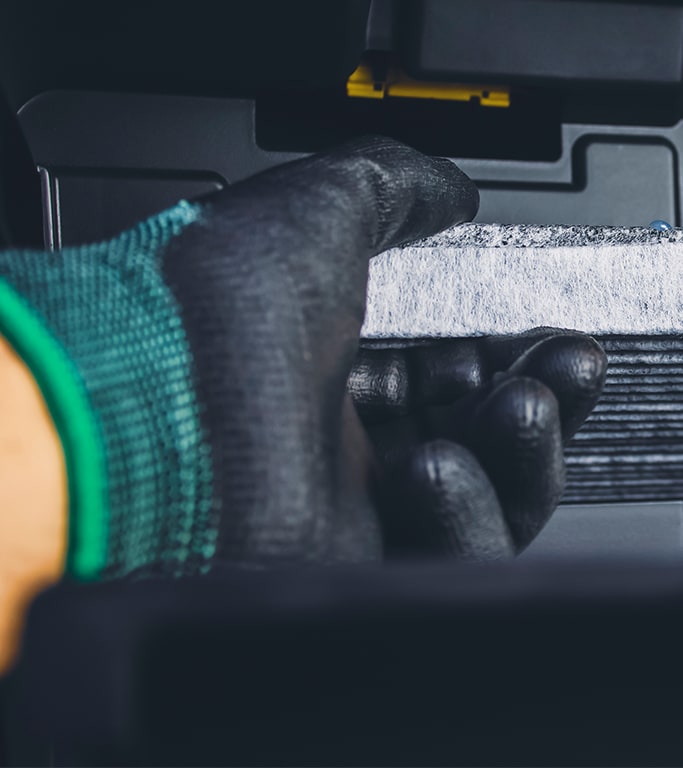 Cabin air filter replacement at Bobby Rahal Toyota | A Hand changing out cabin air filter