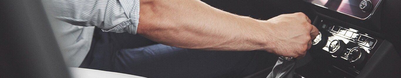 Enjoy A Test Drive At Bobby Rahal Toyota in Mechanicsburg, PA | Man's hand on car shift knob 