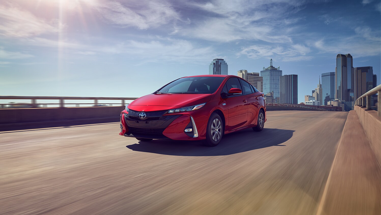 Toyota Hybrid for Everyone at Bobby Rahal Toyota | 2022 Toyota Prius Prime driving on a bridge