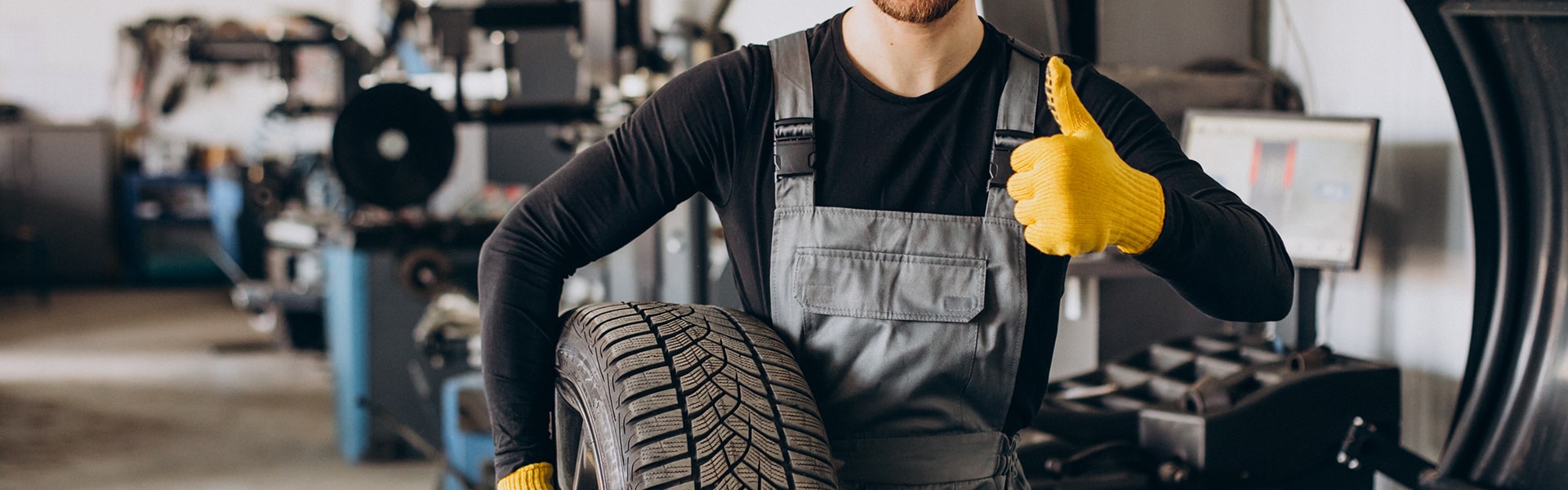 How to check your tires' health at Bobby Rahal Toyota of Mechanicsburg | Toyota technician giving a thumbs up and holdinga new tire