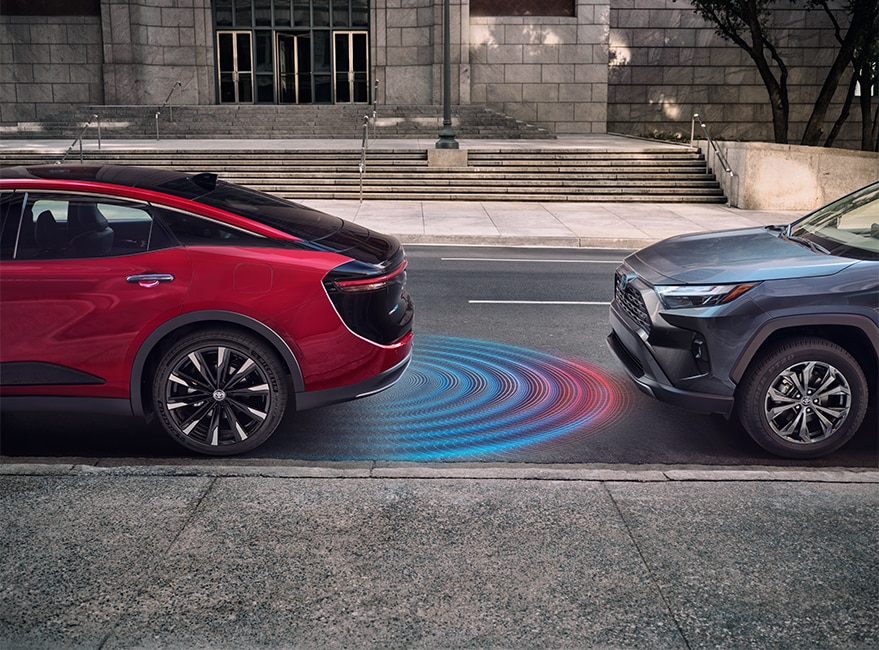 N2023 Toyota Crown at Bobby Rahal Toyota in Mechanicsburg, PA |  A red 2023 Toyota Crown backing into a parking spot with parking sensor technology 