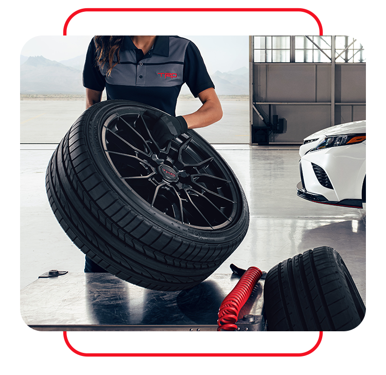 Tire Pressure Information at Bobby Rahal Toyota in Mechanicsburg, PA |. Mechanic placing car tire on a table 