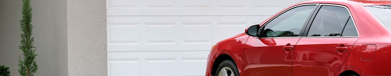 Enjoy A Test Drive At Bobby Rahal Toyota in Mechanicsburg, PA | Red sedan car parked in front of garage door