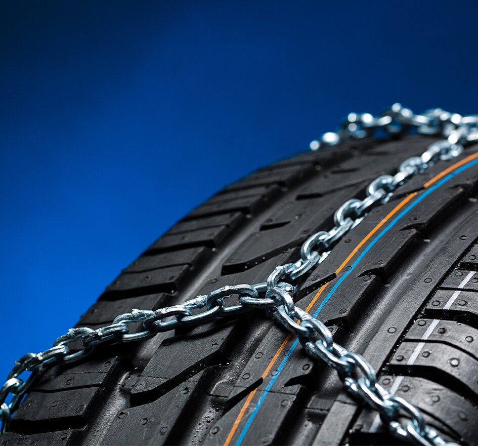 The Cold Facts of Winter Tires | Bobby Rahal Toyota in Mechanicsburg, PA |  Chain attached to winter tires on a blue background 