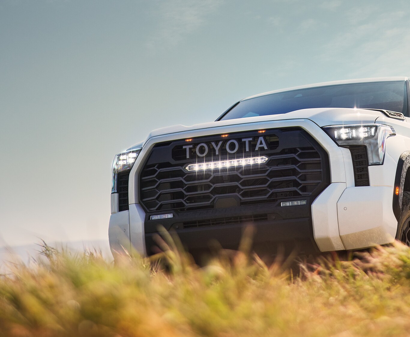 2023 Toyota Tundra vs. 2023 Ford F-150  at Bobby Rahal Toyota | Detail look at the front view of a white 2023 Toyota Tundra 