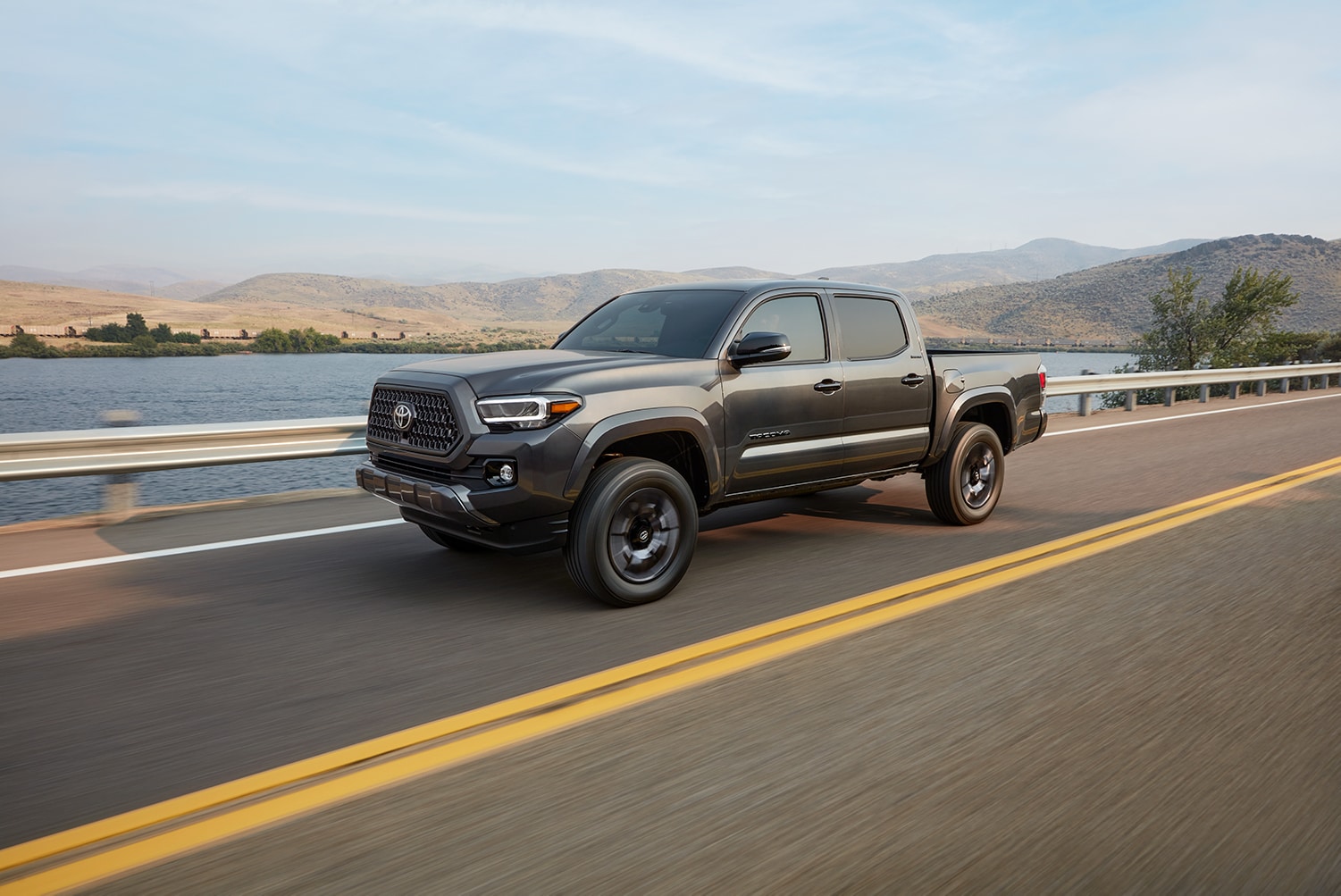 Bobby Rahal Toyota is a Car Dealership near Enola PA | The 2021 Toyota Tacoma driving on a bridge