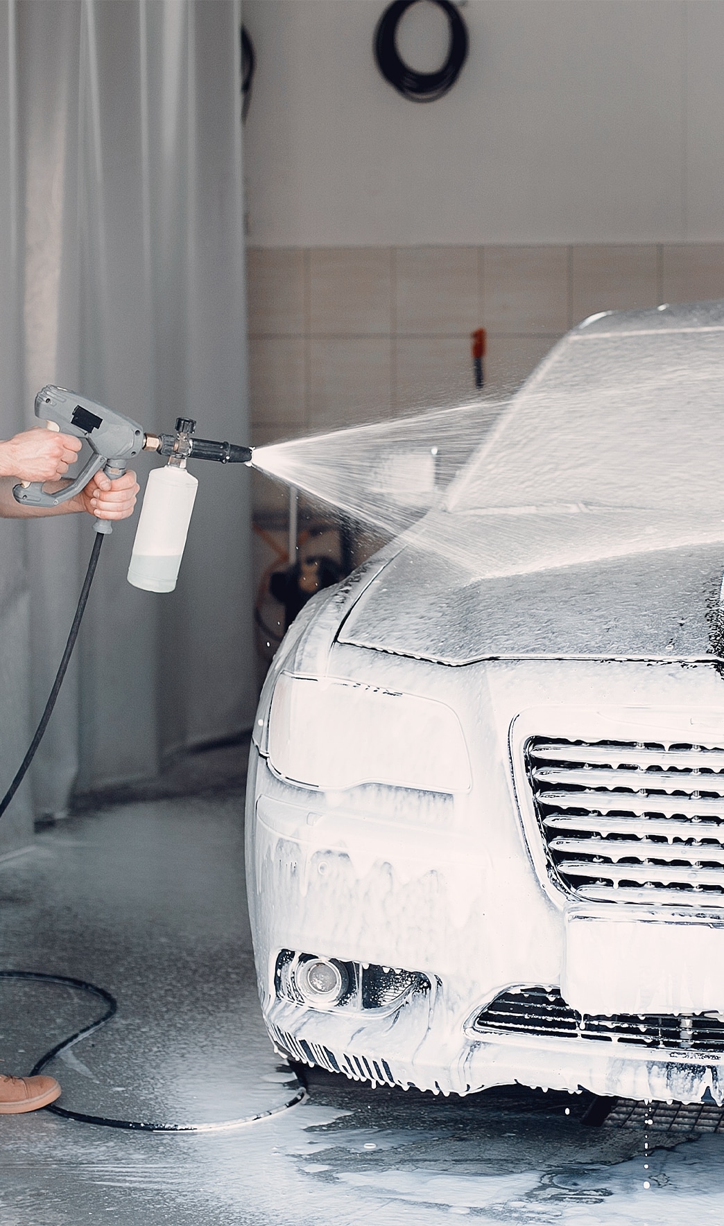 Remove Dead Bugs From Front of Cars at Bobby Rahal Toyota in Mechanicsburg, PA | Power washer being used to spray soap and water onto the front of the car