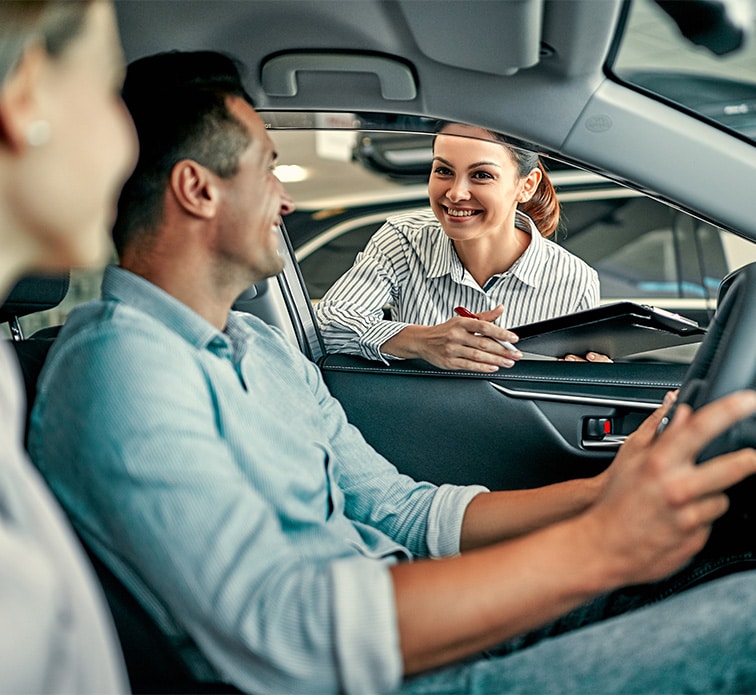 Defining GAP Insurance at Bobby Rahal Toyota in Mechanicsburg | Couple Talking to Sales Advisor Through Car Window