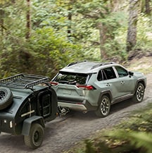 Model Features of the 2021 Toyota RAV4 at Bobby Rahal Toyota | RAV4 pulling trailer on backroads