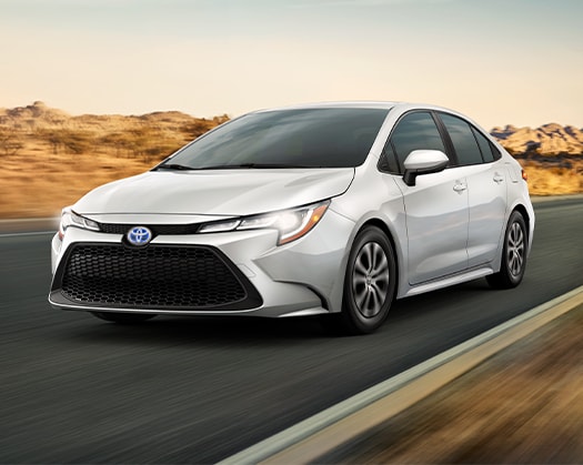 Compare the 2022 Toyota Corolla vs. the 2021 Subaru Impreza at Bobby Rahal Toyota | Corolla driving fast on desert road