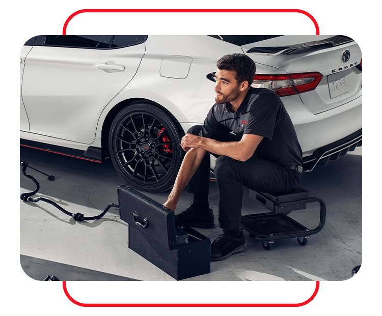 Tire Pressure Information at Bobby Rahal Toyota in Mechanicsburg, PA |  Mechanic sitting on stool after finishing car tire install 