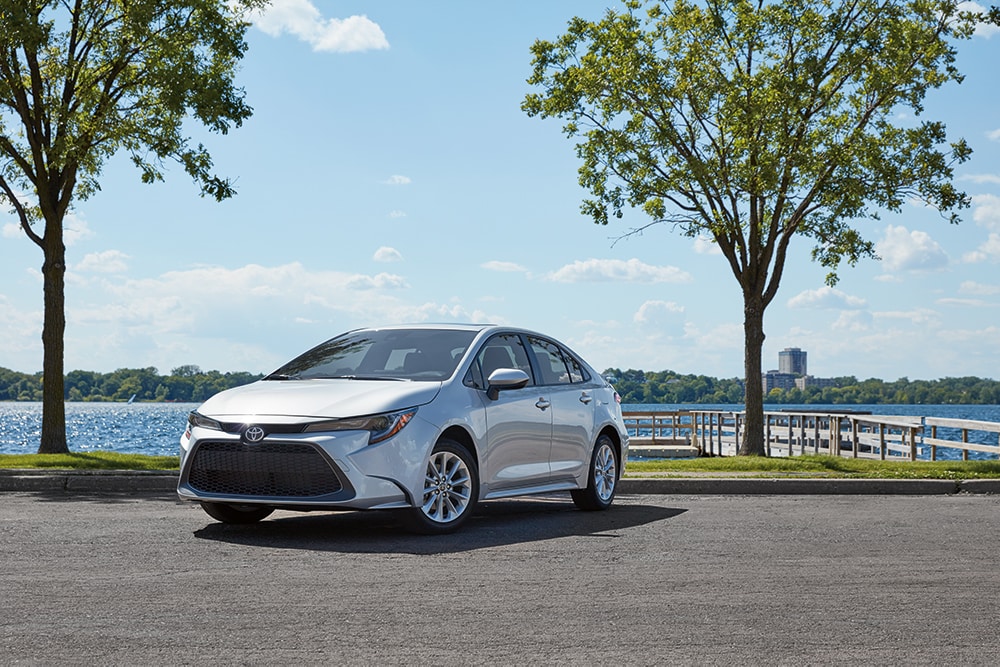 Compare the 2020 Honda Civic Sedan vs. the 2020 Toyota Corolla at Bobby Rahal Toyota of Lewistown | White 2020 Corolla parked on parking lot