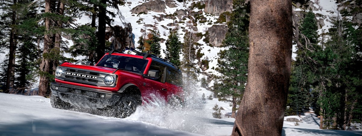 Red 2023 Ford Bronco in snowy mountain terrain