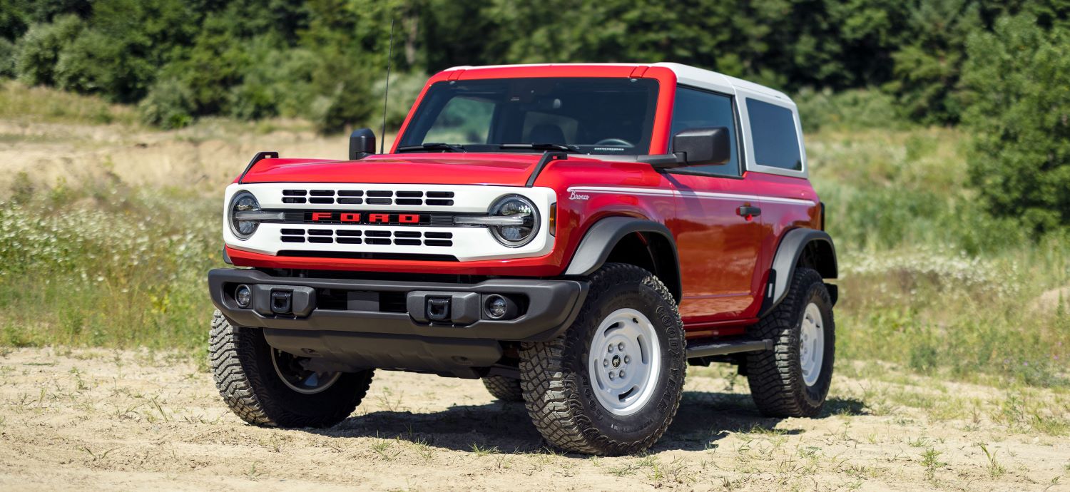 2023 Ford F150 Red Bronco off roading through sandy terrain