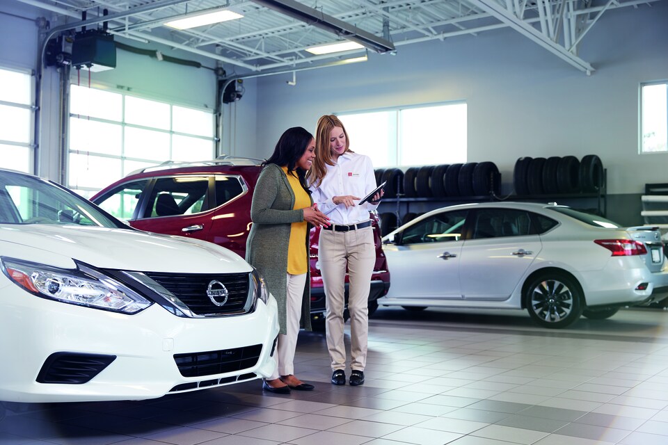 Nissan Service Advisor Explaining Recent Repairs to Customer