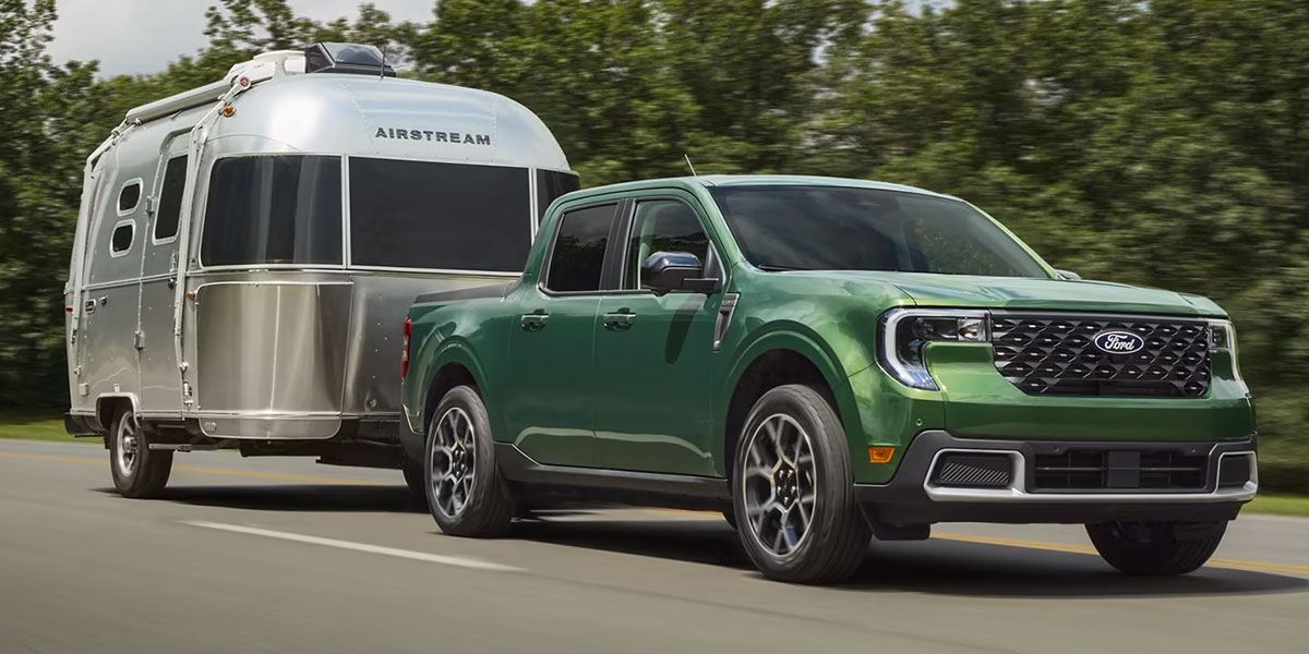 2025 Ford Maverick Driving down the road hauling a trailer
