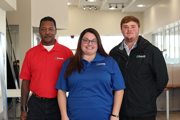 a member of our sales team helping two customers