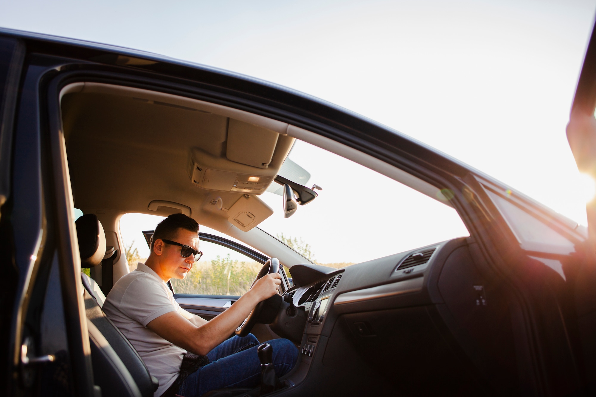 How to change a tire step-by-step guide at Kia of New Bern in New Bern | Man sitting in car