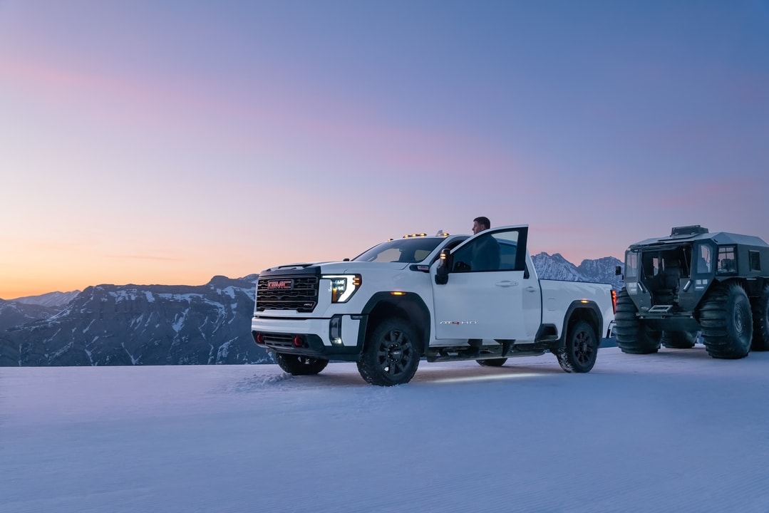 GMC Sierra 2500 Towing with driver standing on the sired