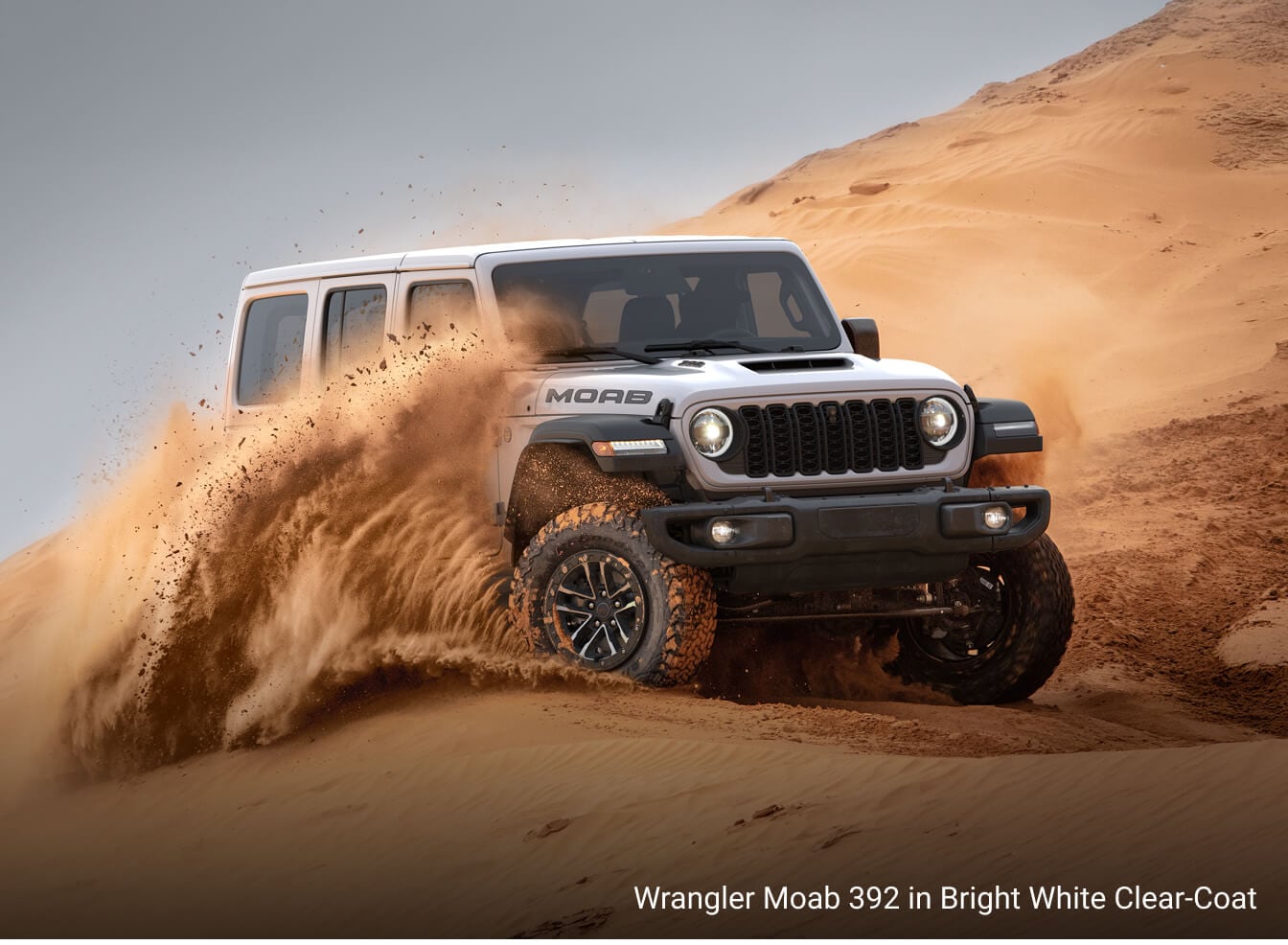 Jeep Wrangler Moab 392 in Bright White Clear-Coat, off-roading in a sand dune