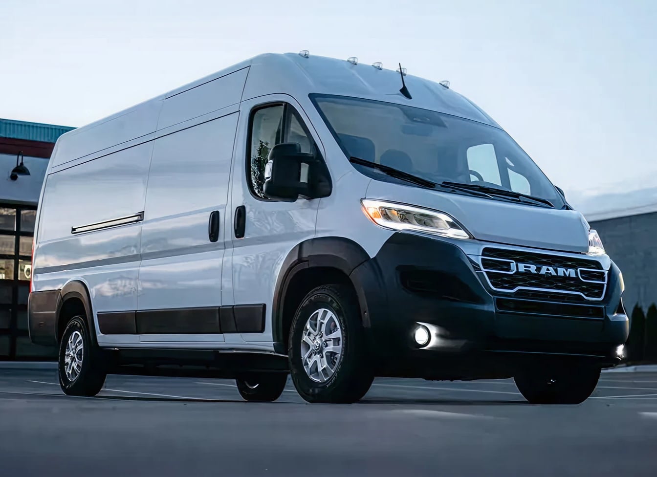 Ram Promaster front right exterior view in dim light with headlinghts on