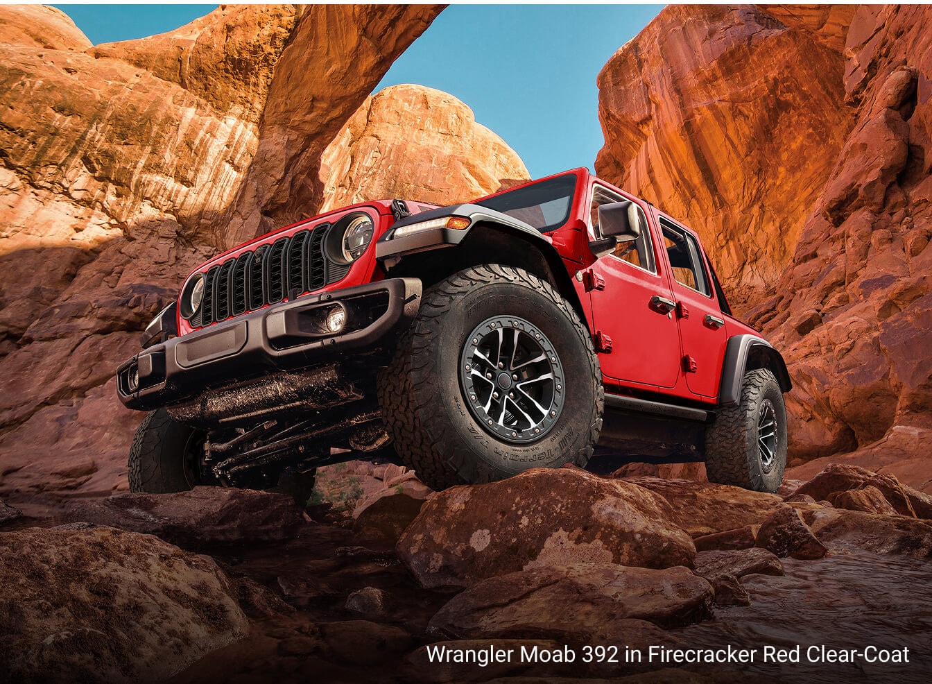 Jeep Wrangler Moab 392 in Firecracker Red Clear-Coat, off roading in rocky and rugged terrain