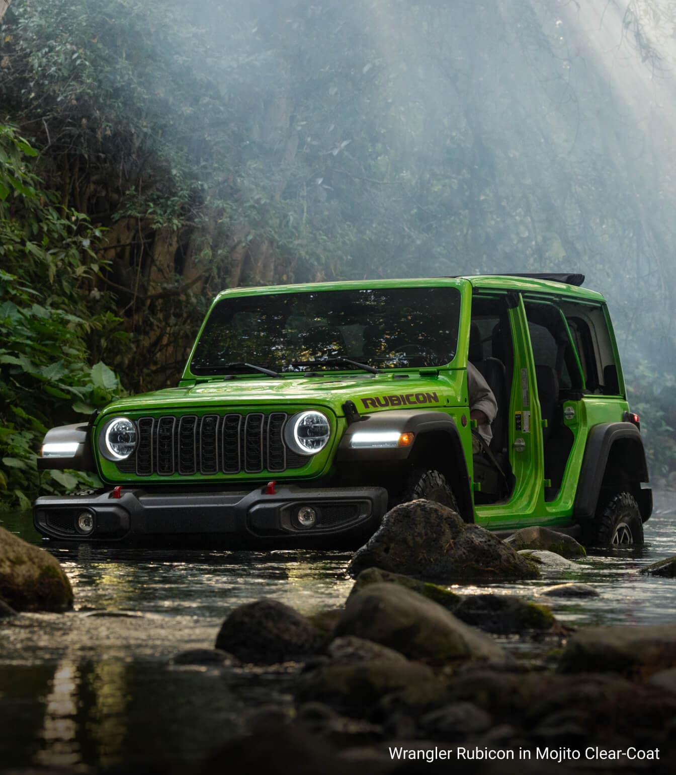 Jeep Wrangler Rubicon in Mojio Clear-Coat, partially submerged and driving in flowing water with doors off