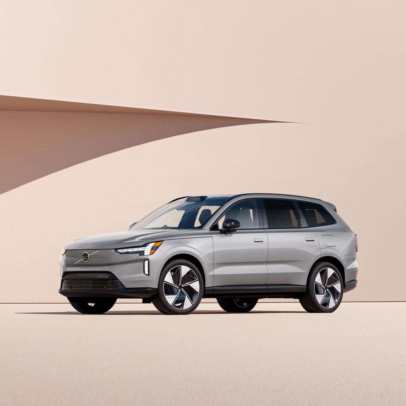 Silver Volvo EX90 electric SUV in studio setting