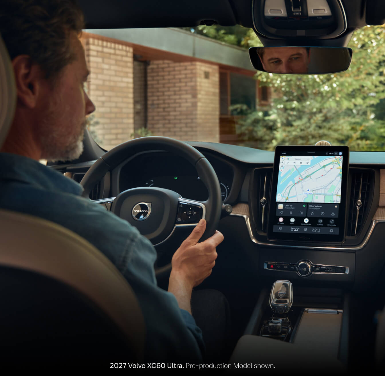 2027 Volvo XC60 Ultra with Cardamom interior viewed over the driver's shoulder showing the steering wheel.