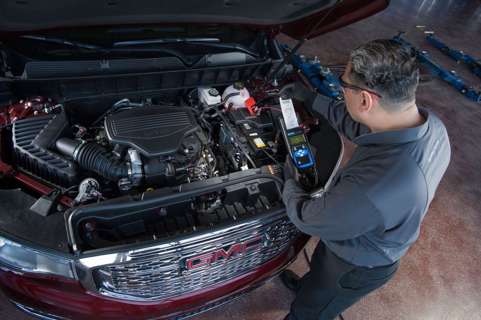 GMC service technician working on an SUV
