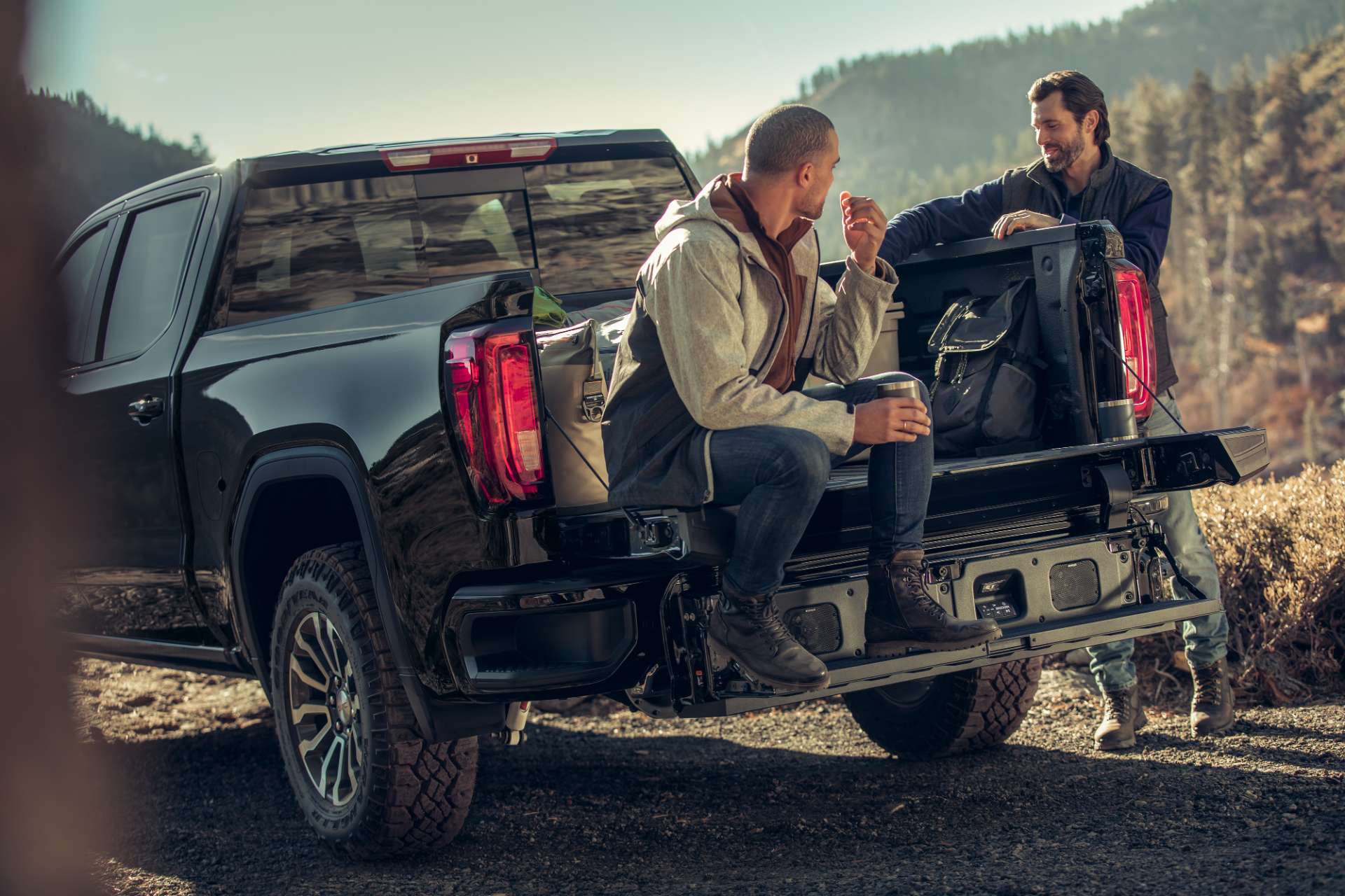 Friends sitting on the back of a GMC truck