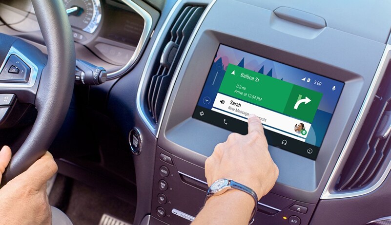 A driver in Grand Rapids, MI using Ford SYNC 3 to easily respond to a message while getting driving directions
