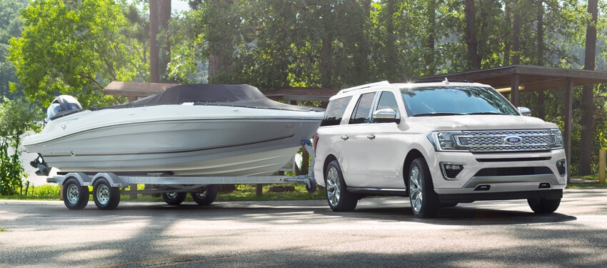 The New 2018 Ford Expedition towing a boat near one an inland lake in West Michigan