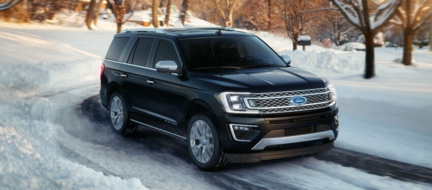 A 2018 Ford Expedition easily driving down a snowy road in Grand Rapids, MI